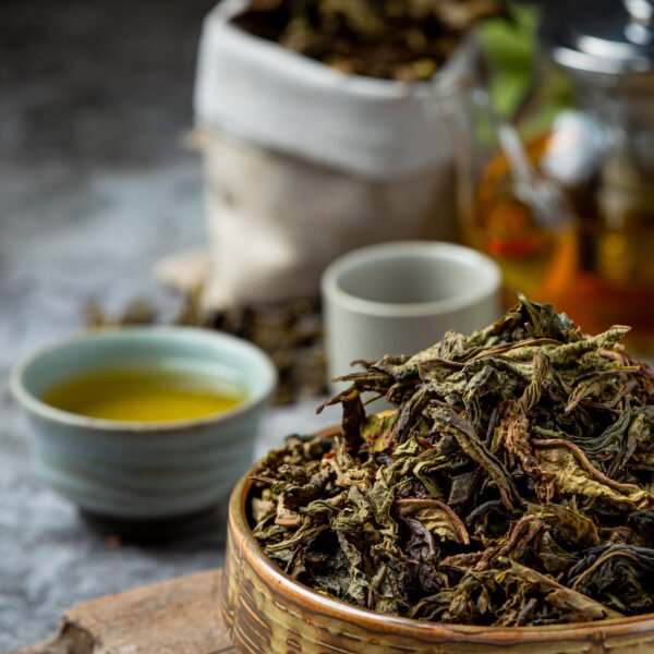 Oolong green tea in a teapot and bowl.